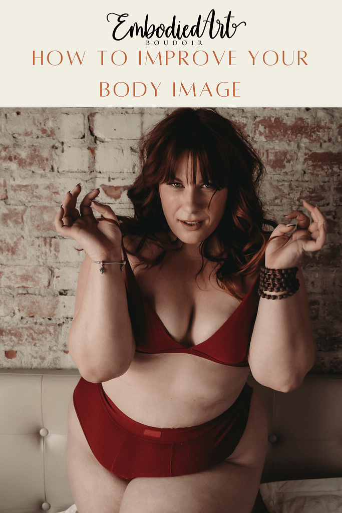 Plus size red haired woman standing confidently looking sultry wearing a matching red bra and briefs. Photo by Embodied Art Studio. Denver boudoir photographer, denver boudoir photography, boudoir, colorado boudoir, denver boudoir, body positive, body positivity, body neutrality, body neutral, fat positive, plus size, petite, body image, body love, self love, self compassion, mirror work, boudoir photos, sexy photos, mindset, beautiful bodies, healing body image