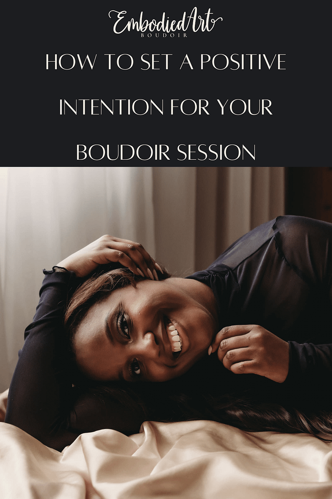 Woman smiling, looking directly at camera happily touching side of face wearing a sheer black shirt. Photo by Embodied Art Boudoir. Intentions, intention setting, goal setting, boudoir photoshoot, boudior, buodoir, Denver boudoir, Colorado boudoir, boudoir photographer, self love, growth journey, affirmations, positive intentions, positive affirmations, self love journey, boudoir photography, Denver portrait photography, Denver portrait photographer, Boulder boudoir, fort collins boudoir, colorado springs boudoir, how to set an intention
