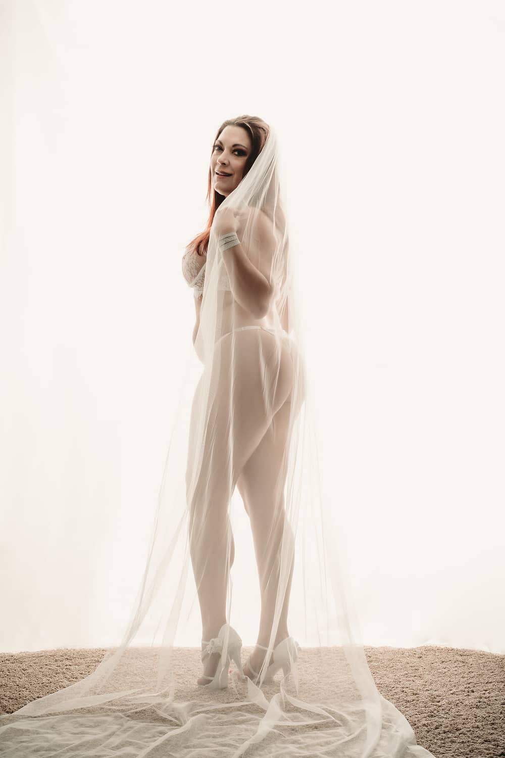 Woman standing in white pantie and thong, wearing a veil. Photo by Embodied Art Boudoir, boudoir posing, boudoir inspiration, plus size photography, plus size boudoir, plus size glamour, plus size posing, plus size outfits, fat boudoir, fat empowerment, body positivity, fat positive, body positive, body confidence, body empowerment, haes, colorado boudoir, denver boudoir. 

