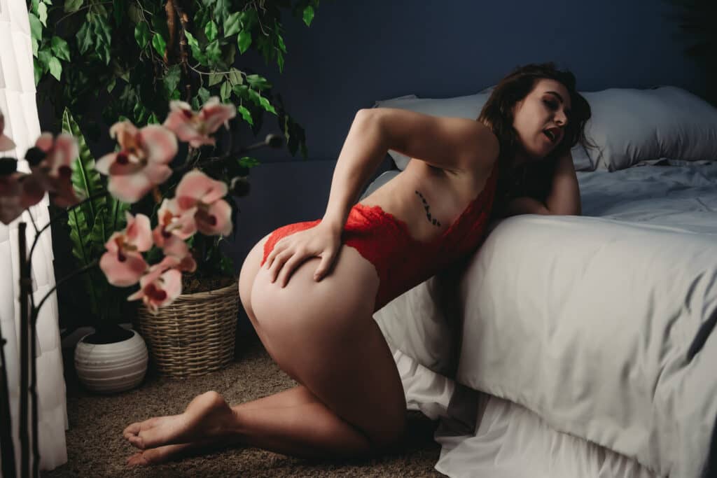 Woman leaning on the bed wearing a thonged red body suit. Photo by Embodied Art Boudoir. Boudoir photography, do what scares you, fear is growth, hype lady, boudoir fun, growth, embrace change, nerves,  boudoir photography, female photographer, gorgeous images, meditation, good vibes, colorado boudoir, denver boudoir, boulder boudoir, colorado springs boudoir, boudoir ideas, boudoir poses, boudoir inspiration, photography inspiration, 

