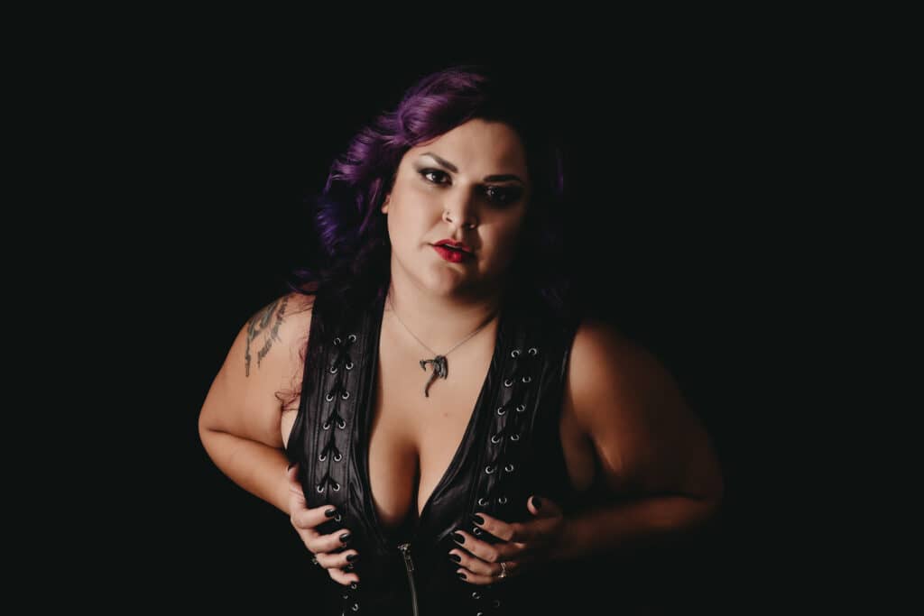 Woman with purple hair wearing a leather corset, leaning towards camera. Photo by Embodied Art Boudoir. Boudoir photography, do what scares you, fear is growth, hype lady, boudoir fun, growth, embrace change, nerves,  boudoir photography, female photographer, gorgeous images, meditation, good vibes, colorado boudoir, denver boudoir, boulder boudoir, colorado springs boudoir, boudoir ideas, boudoir poses, boudoir inspiration, photography inspiration, 

