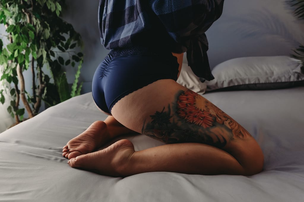 Photo of womans booty wearing blue panties and plaid blue shirt. Embodied Art Boudoir studio is rooted in body positivity, a space that invites you to feel safe, heard, and empowered. I sincerely encourage you to come to our Body Positive Boudoir Studio as you are: the focus of the shoot is to celebrate you as the work of art you already are. When you step into your session, I capture you in the space you’re in that day. A candid, timeless depiction of beauty – ‘imperfections’ and all.