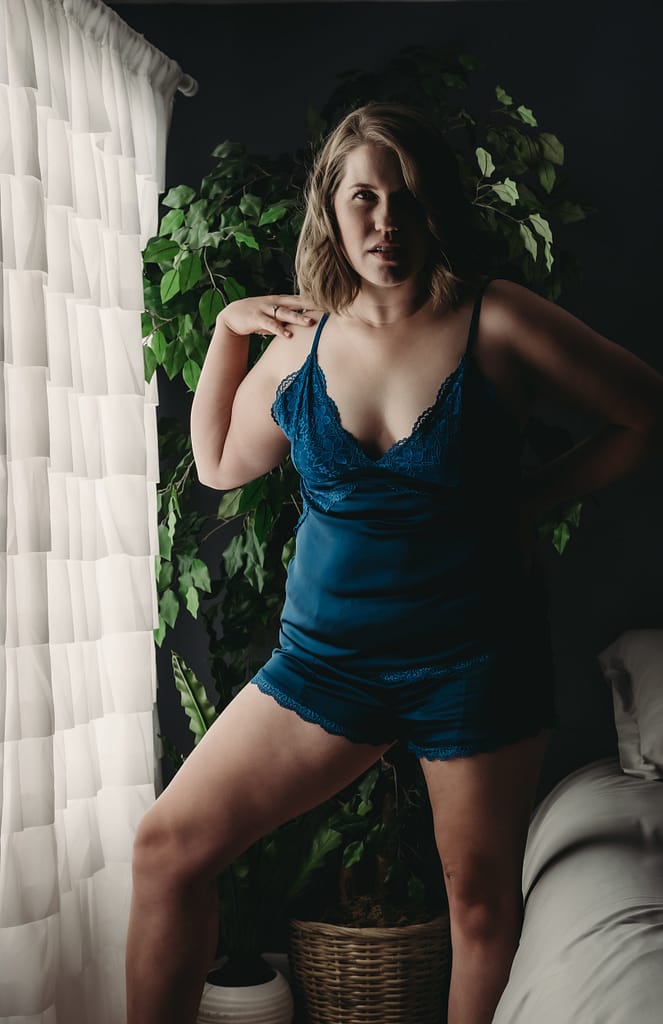 Blonde woman standing strong looking directly at camera wearing rich blue matching lingerie set. Photo by Embodied Art Boudoir. Mindfulness, intention, focus, multitasking, single tasking, cultivating attention, presence, longer attention span, short attention span, meditation, daily practice, silence, learning, space, creating space, yoga, buddhism