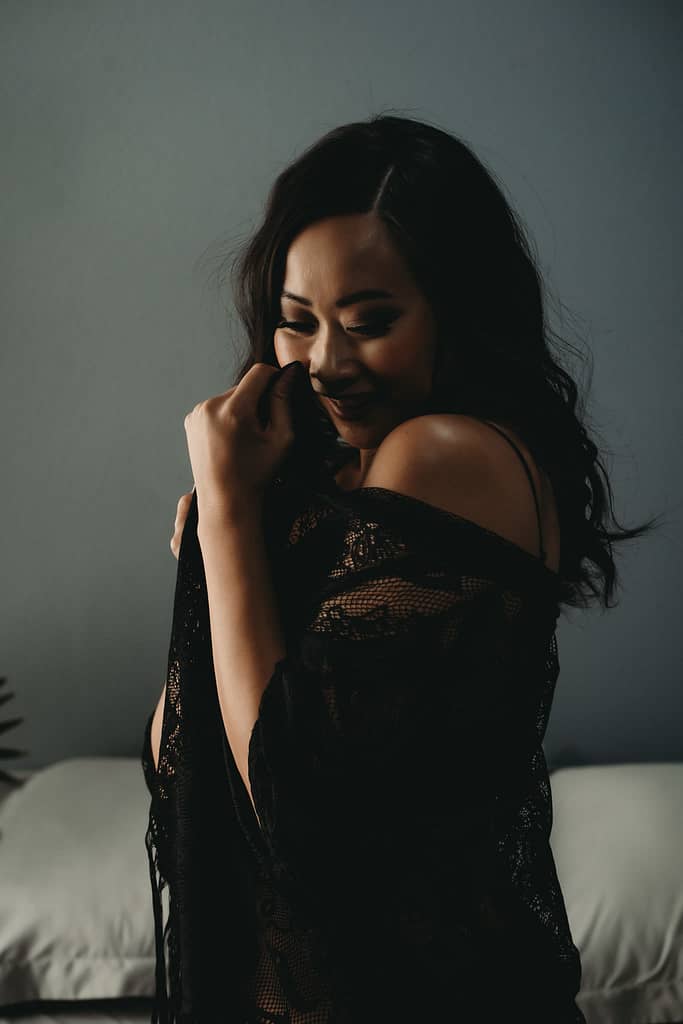 Woman standing looking to the ground with a shy smile, wearing a lacy black robe. Photo by Embodied Art Boudoir. Modest boudoir photography, Modest Fashion, Modest Woman, Fashion Trends, Shy, classy photography, classic boudoir, classy boudoir, feminine photography, colorado boudoir, denver boudoir, boulder boudoir, colorado springs boudoir, boudoir ideas, boudoir poses, boudoir inspiration, photography inspiration, boudoir session, boudoir photos