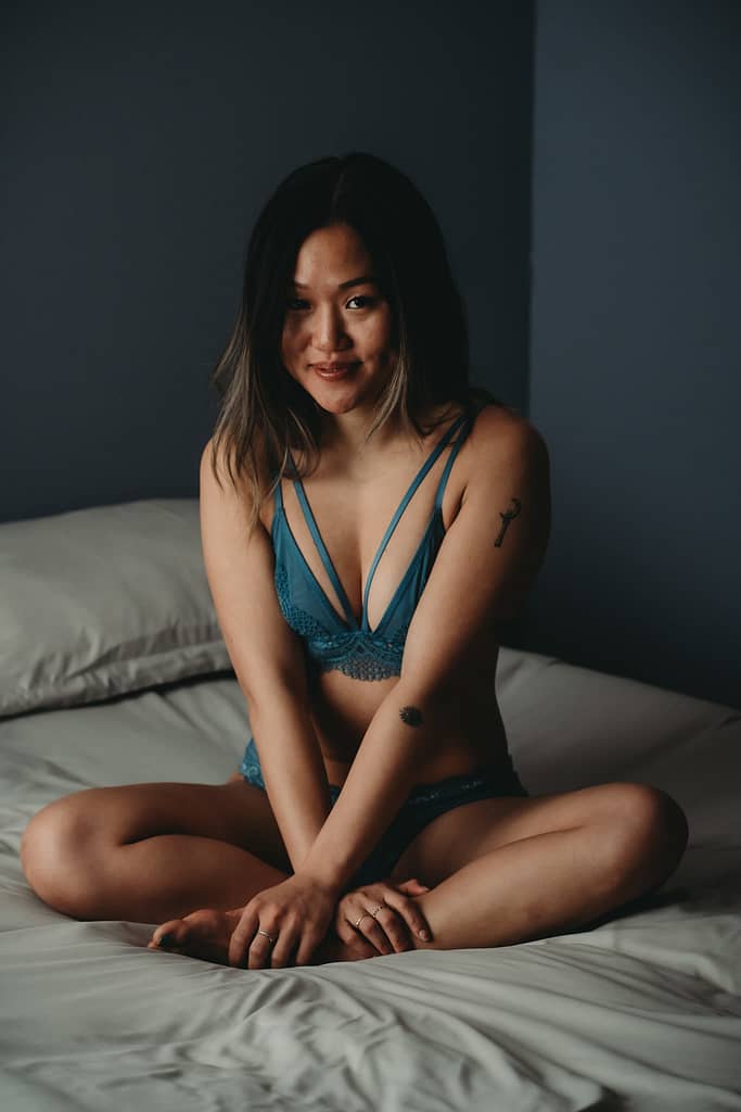 Woman sitting cross-legged on the bed wearing a matching blue bralette and panty set. Photo by Embodied Art Boudoir. Boudoir outfits, boudoir lingerie, boudoir fashion, boudoir babes, boudoir inspo, boudoir fashion, boudoir dress, boudoir style, personal style, favorite outfits, blogging, boudoir ideas, lingerie, colorado boudoir, boudoir, denver boudoir, denver boudior, boulder boudoir, colorado springs boudoir, boudoir ideas, photoshoot accessories, outfit inspiration, photoshoot outfit

