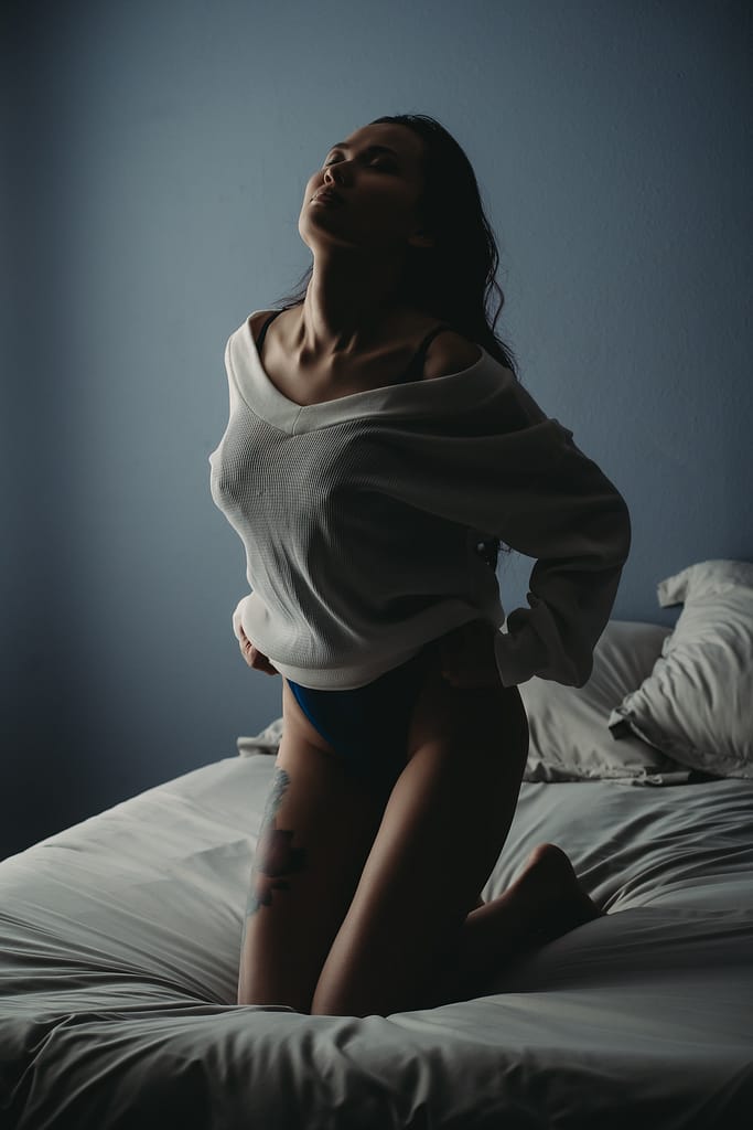 Woman standing on knees, wearing a white sweater and black panties. Photo by Embodied Art Boudoir, cozy, cozy boudoir, cozy vibes, cozy outfits, cozy and comfortable, cozy boudoir photography, cozy inspiration, keep it cozy, boudoir outfit, boudoir outfit inspiration, what to wear to boudoir, colorado boudoir, denver boudoir, boulder boudoir, colorado springs boudoir, boudoir ideas, boudoir poses, boudoir inspiration, photography inspiration