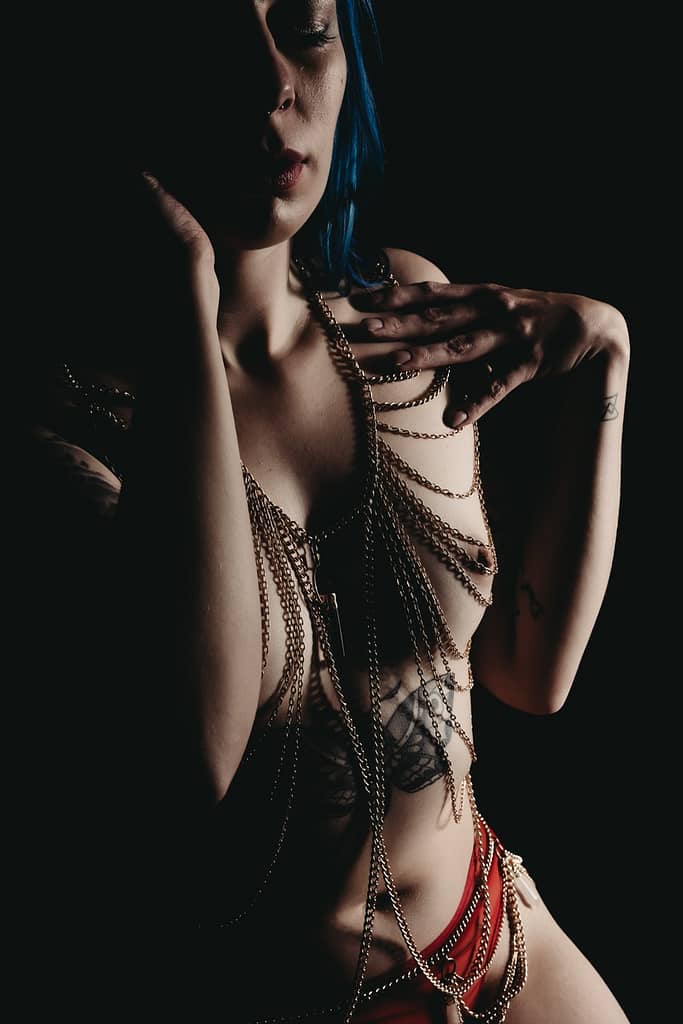 Woman wearing body chains and red panties and nothing else. Photo by Embodied Art Boudoir. Embrace sensuality, sensual, wellness, connection, embodied, desires, five senses, connected, imperfectly perfect, body journey, body love,  colorado boudoir, denver boudoir, boulder boudoir, colorado springs boudoir, boudoir ideas, boudoir poses, boudoir inspiration, photography inspiration