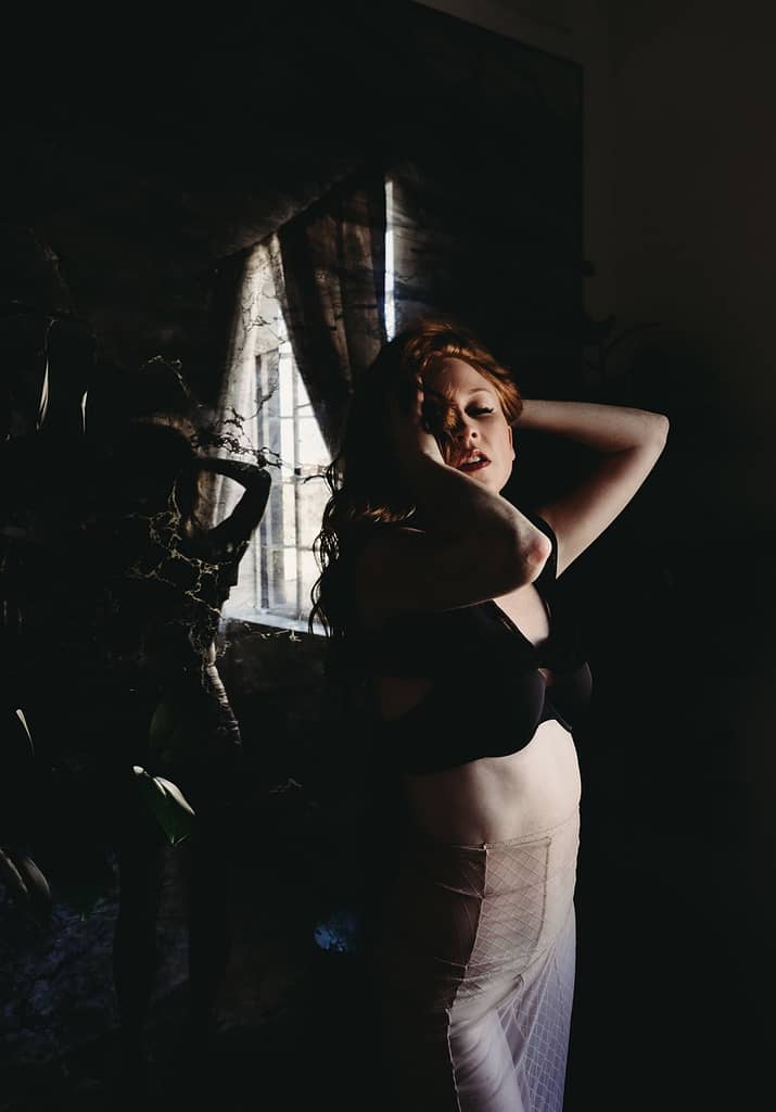 Woman standing near mirror wearing a beige colored skirt and black bra running her hands through her hair. Photo by Embodied Art Boudoir. Growth, confidence, self-confidence, boundaries, boundary, boundary setting, saying no, self-worth, female empowerment, self-love, self-care practice, healthy relationships, emotional boundaries, physical boundaries, boundaries with family, boundaries at the holidays, boudoir, boudoir photo shoot, boudoir inspiration, colorado boudoir, denver boudoir, boulder boudoir, colorado springs boudoir