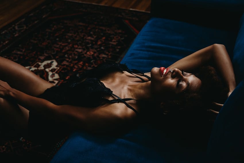 Woman lying down wearing a black strappy body suit. Photo by Embodied Art Boudoir. Boudoir images, powerful women, sexy at any weight, body confidence, body image, self love, self confidence, changes, confident women, self care practices, challenge yourself, boudoir inspiration, boudoir images, colorado boudoir, denver boudoir, boulder boudoir, colorado springs boudoir, female photographer, body positive studio

